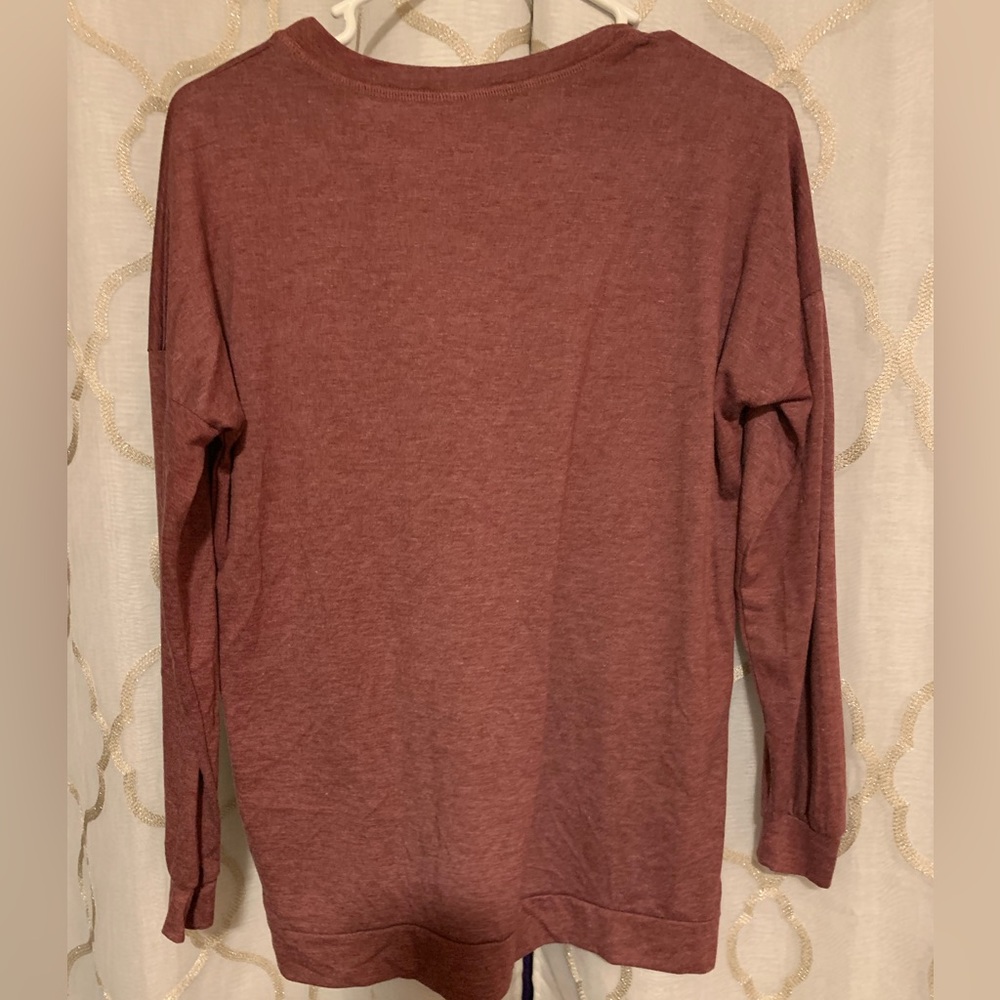Medium long sleeve, maroon shirt with saying on the front